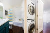 Bathroom and build in washer dryer bathroom sink toilet and tub..