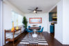 Dinning room with round table and four blue chairs kitchen entrance adjacent.