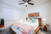 Bedroom with kingsize bed and wooden bed frame and side tables.